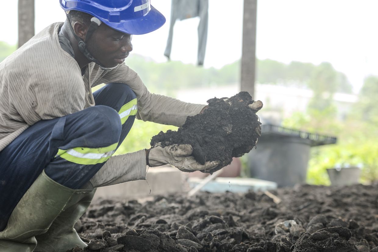 Workers examining the fresh soil