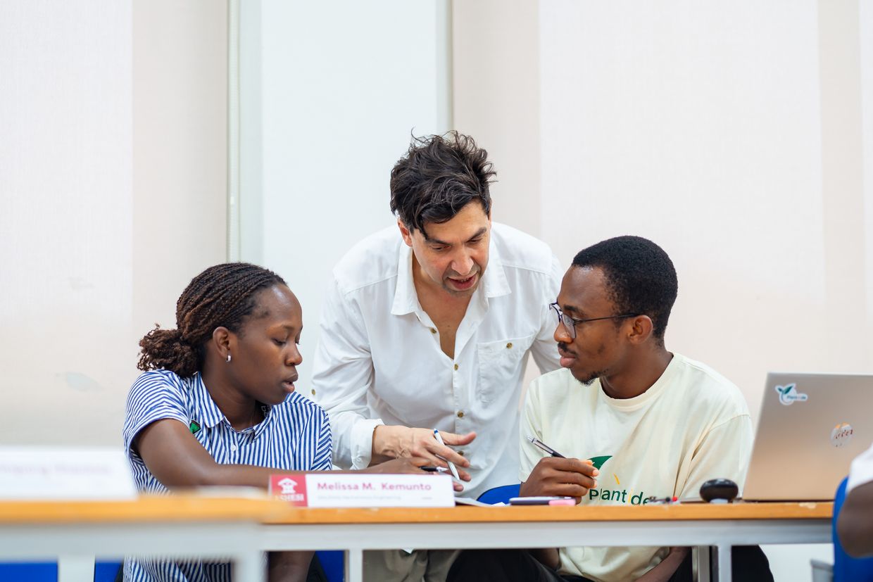 Professor in conversation with two students.